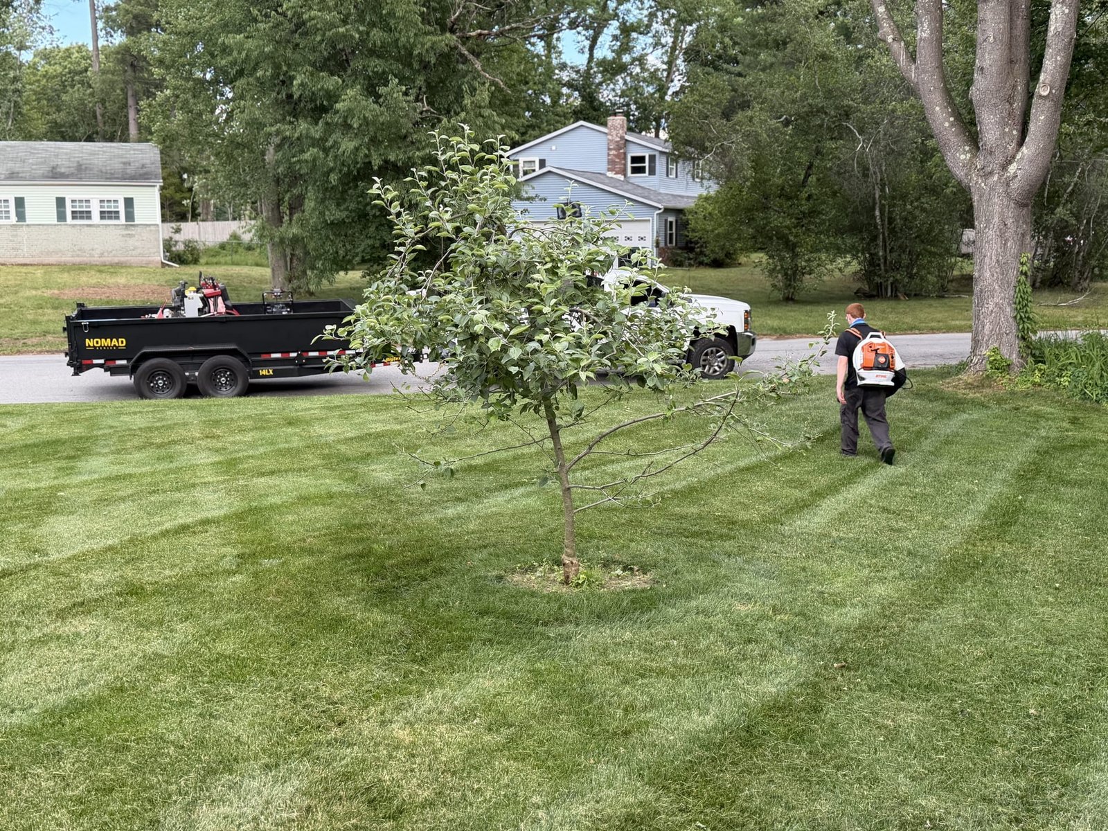 The crew working on site with the mowing rig and equipment staged nearby.